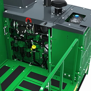 Close-up of an internal knuckleboom loader compartment with metal housing, exposed engine components, filters, hoses, and a grated side panel