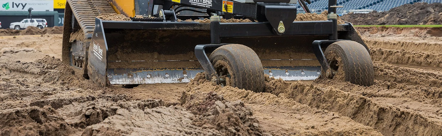 Close-up front view of the bolt-on steel cutting edge of a box blade attached to the front of a 333G compact track loader