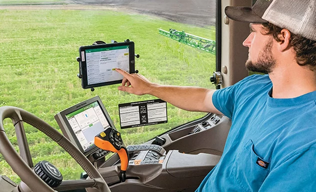 Man operates Operations Center PRO Dispatch screens in cab