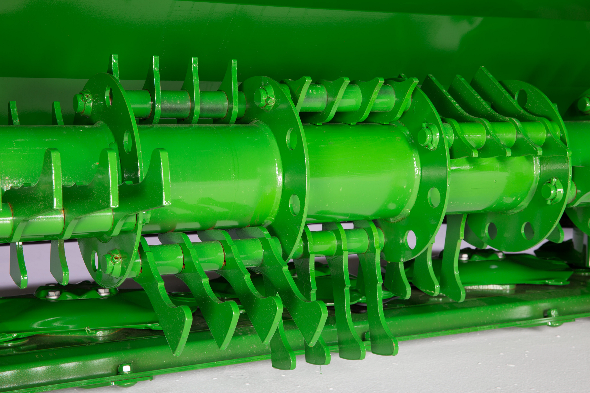 Close-up studio view of a R990R Rear Mount Mower-Conditioner's pivoting steel fingers