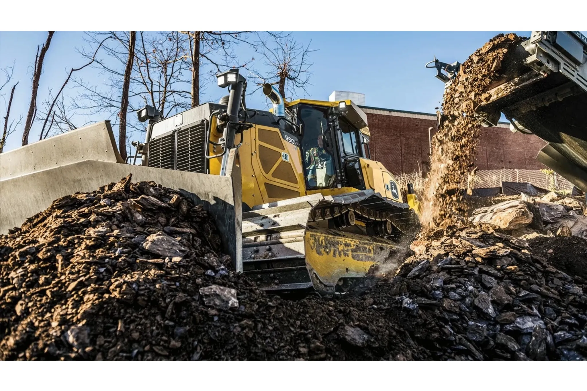 950 P-Tier Large Dozer pushes roadbuilding debris.