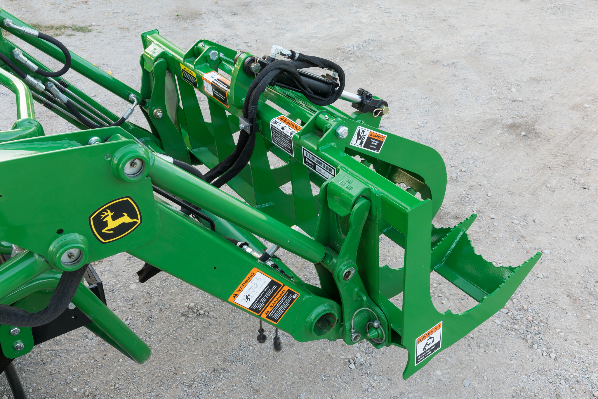 Top right view of a 2025R tractor with attached, closed AV2053F root grapple