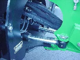 Close-up of a 485 backhoe's twin double-acting hydraulic cylinders and connection point to swing frame