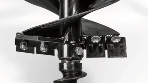 Studio close-up of the anti-burying plate on a black post hole digger's auger