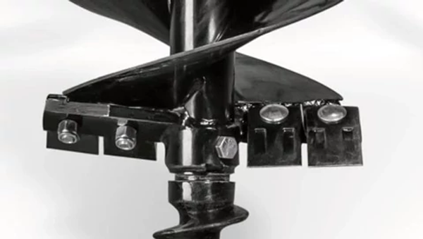 Studio close-up of the anti-burying plate on a black post hole digger's auger