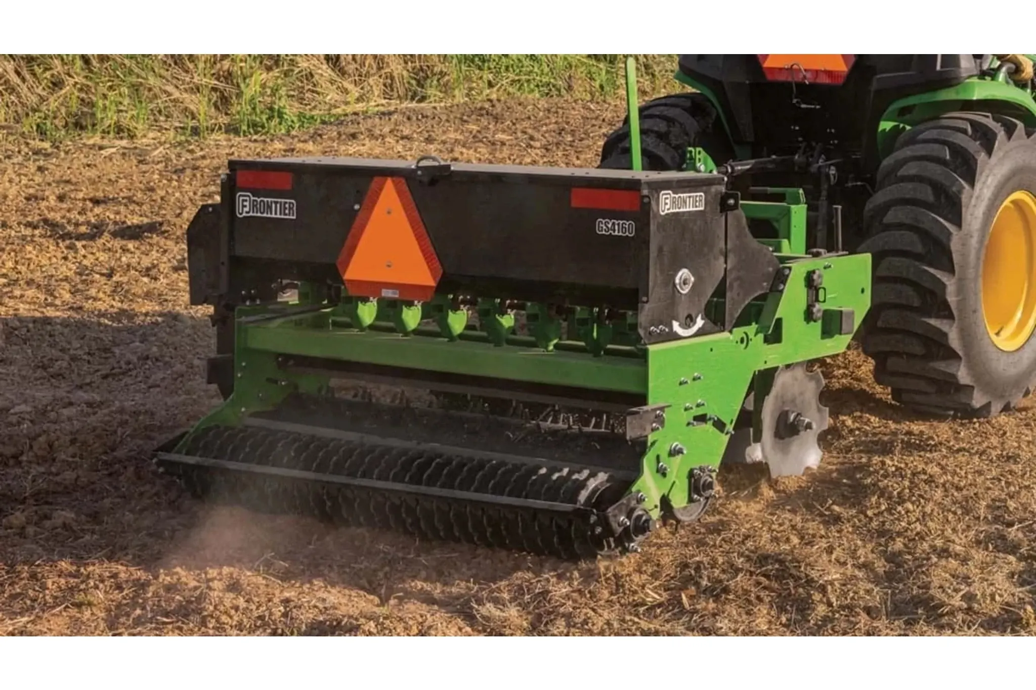 Rear right view of Frontier GS4160 Ground Seeder seeding a dirt field
