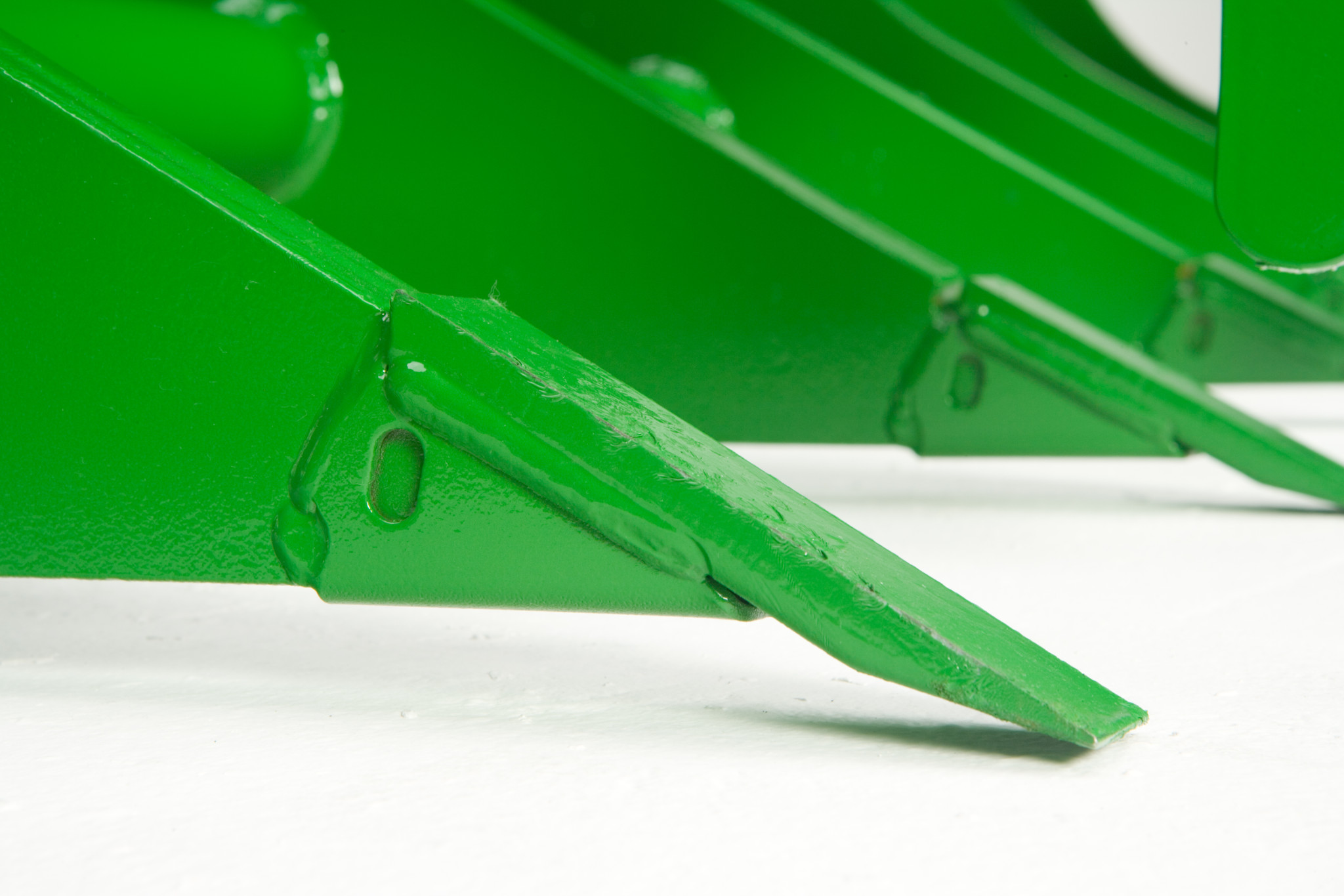 Close-up side view of wear tips on the AV20E Root Grapple
