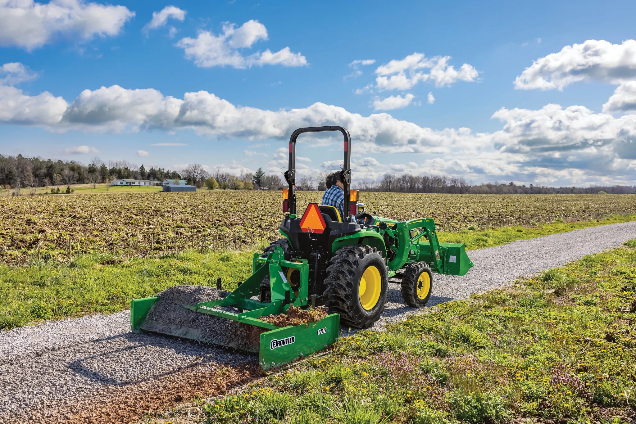 LP2172 Land Plane on 3038E Tractor leveling gravel on path in a field