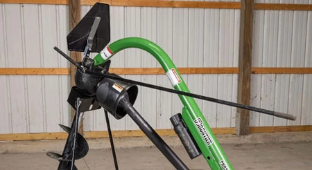 PHD395 post hole digger with auger positioning handle standing in a shop