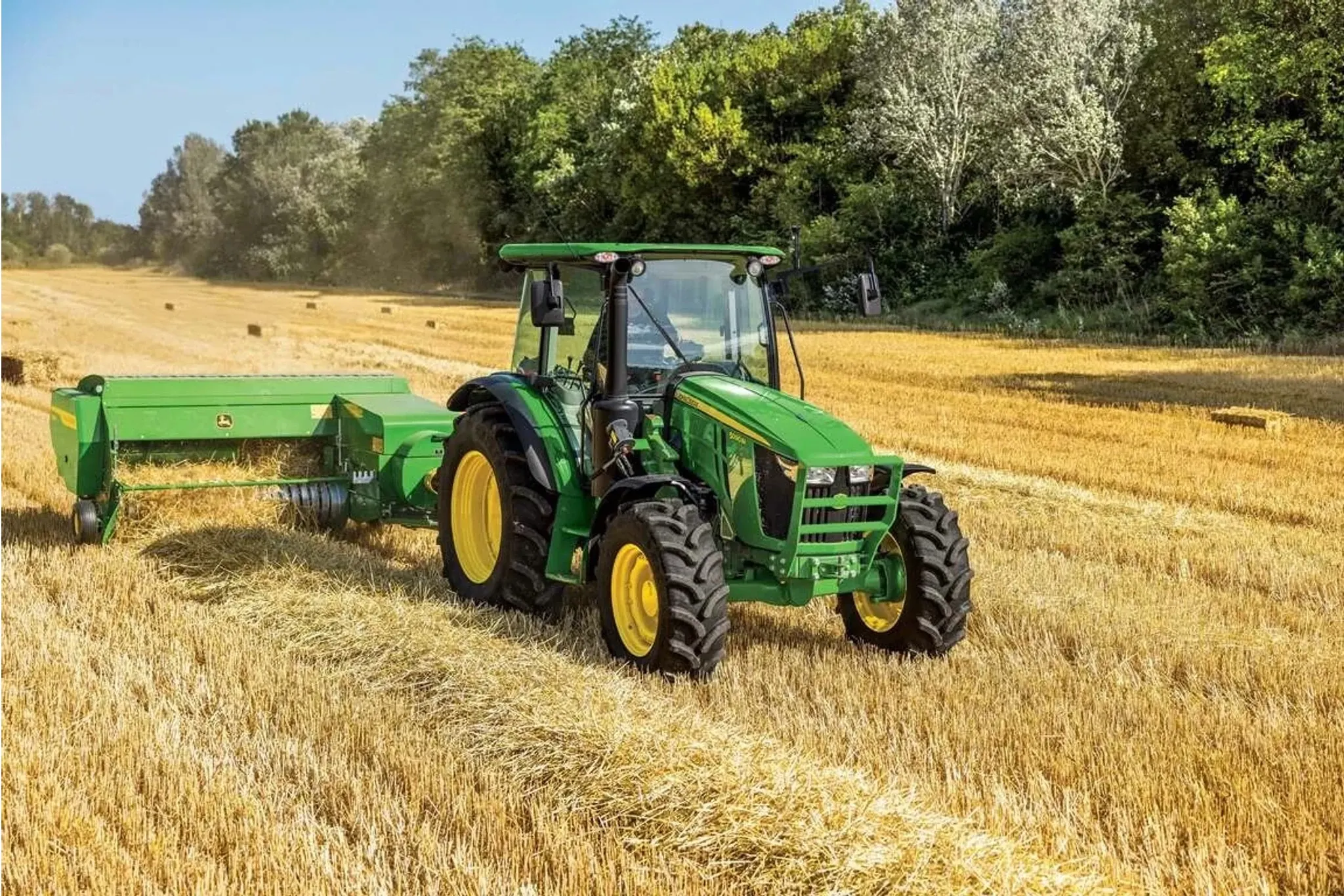 Farmer using an S200 Small Square Baler to bale hay