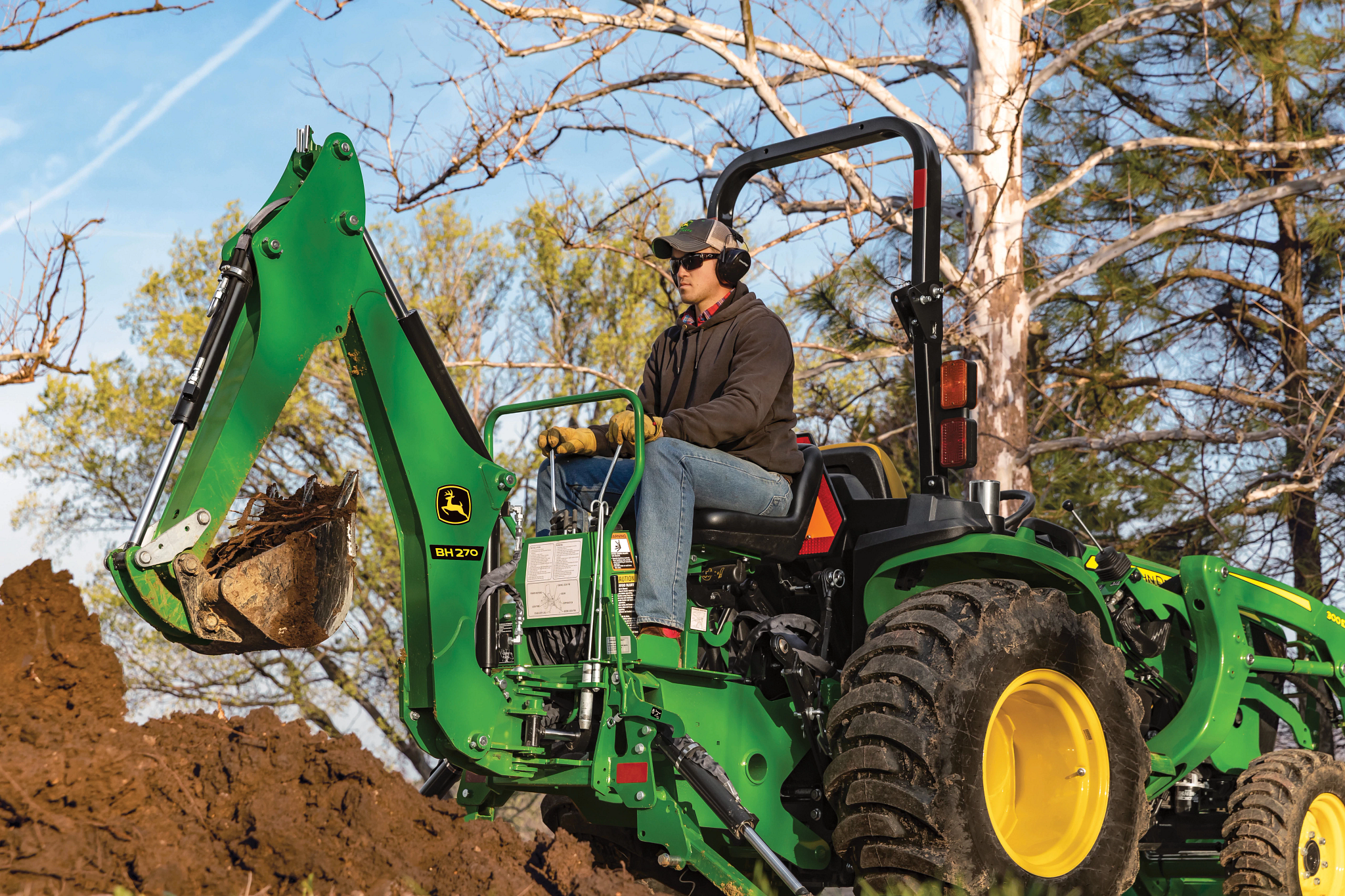 Backhoe in the woods with operator