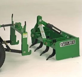 Green Frontier box blade attachment featuring multiple curved scarifier shanks, sitting behing a tractor hitch assembly ready to be hooked up