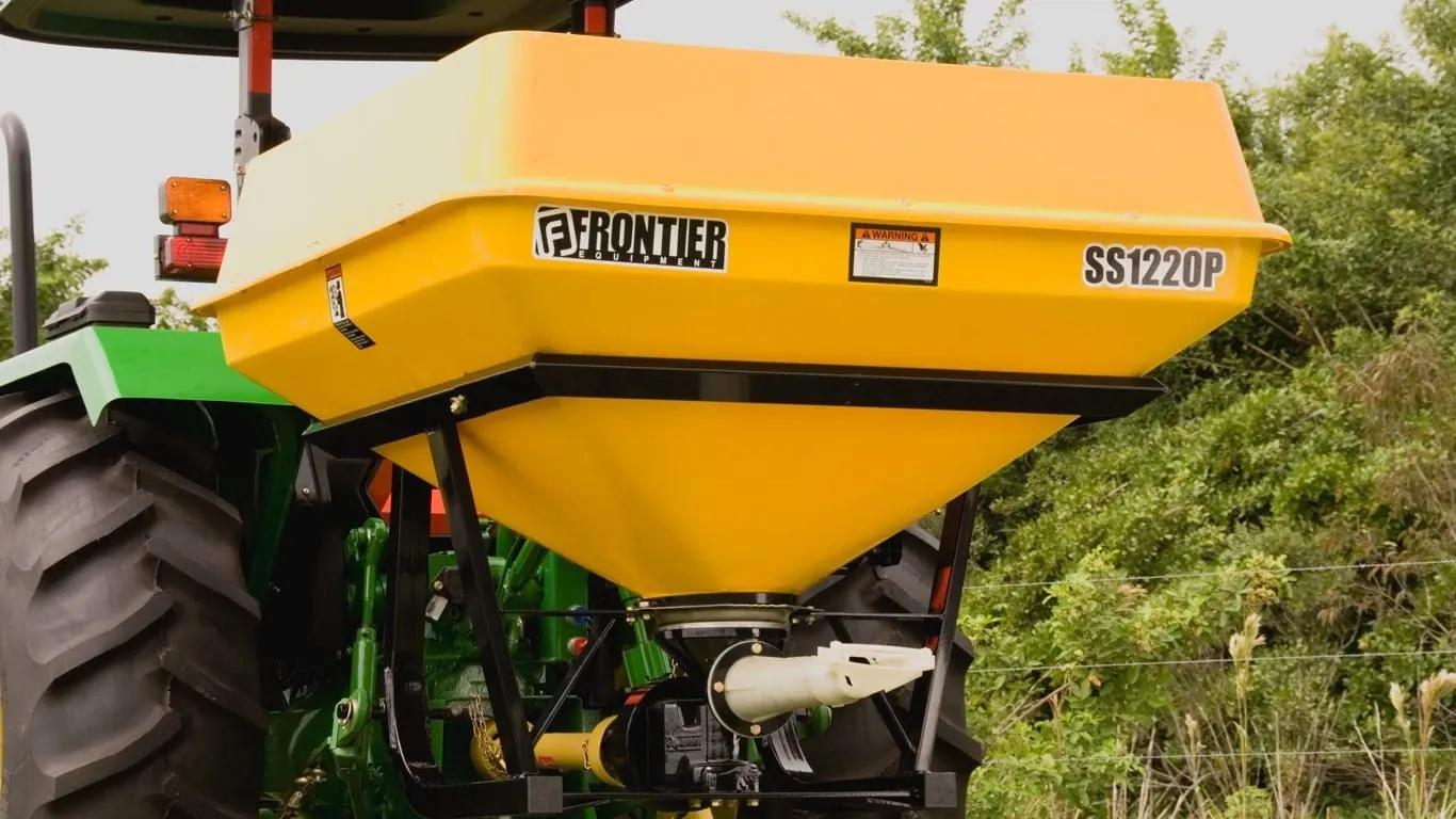 Field image of SS1220P pendular spreader attached to rear of Tractor