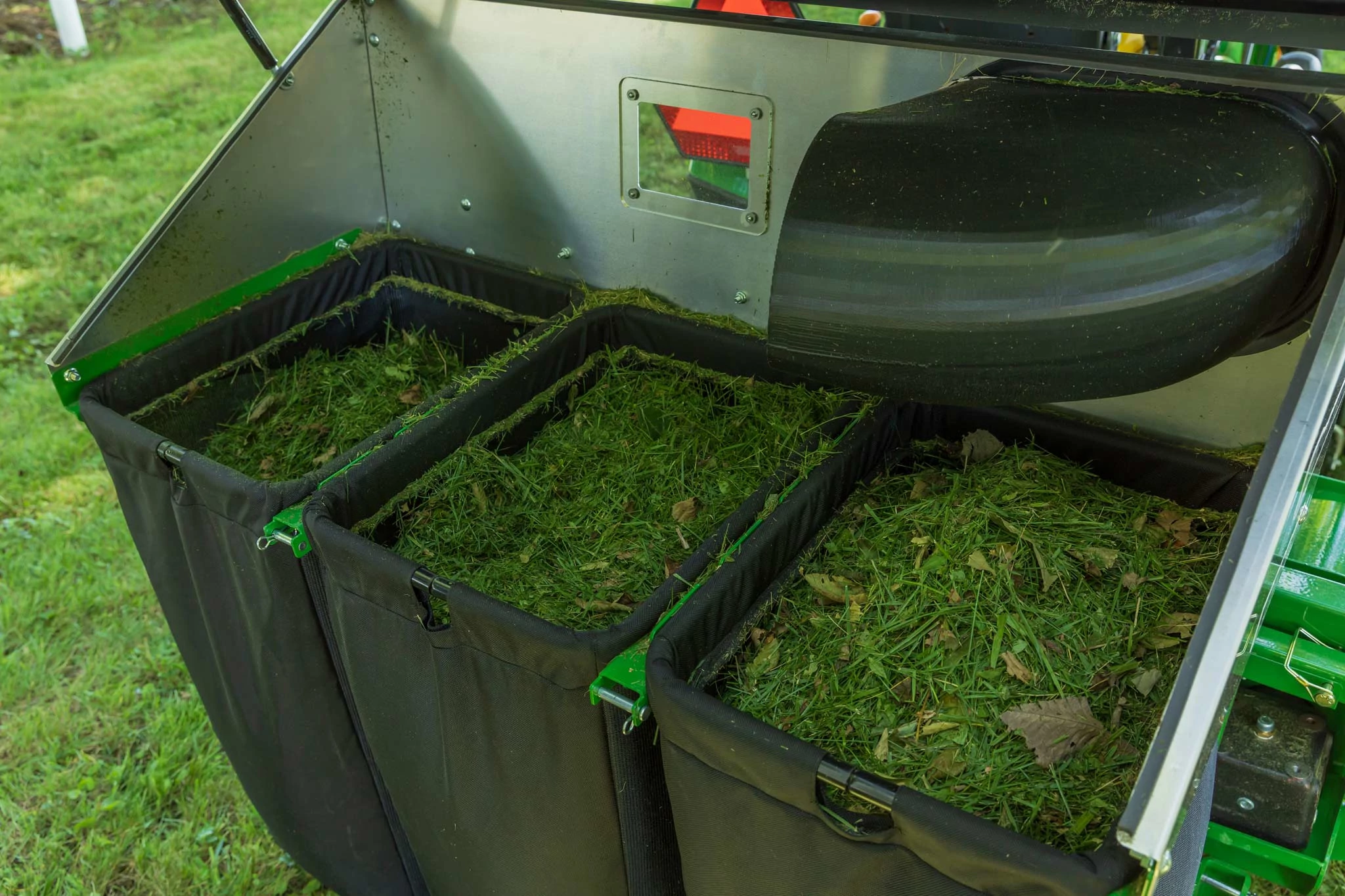 Close-up of an MC2014 material collection systems' three grass-filled bins