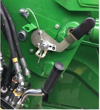 Close-up of a 600R series loader's mast latch system, locked with pin installed