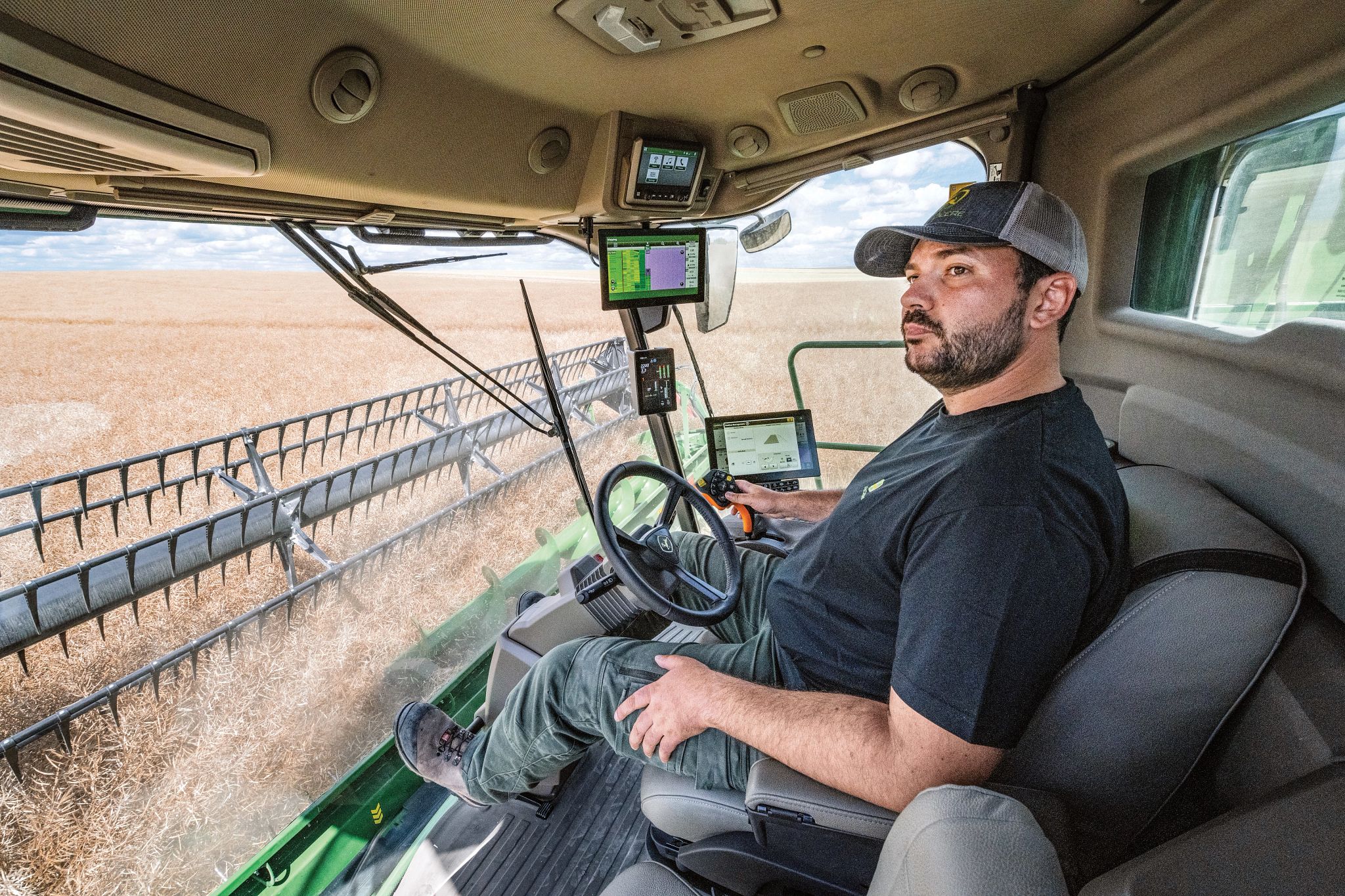 Left side view inside a T6 800 combine of the operator looking to the left