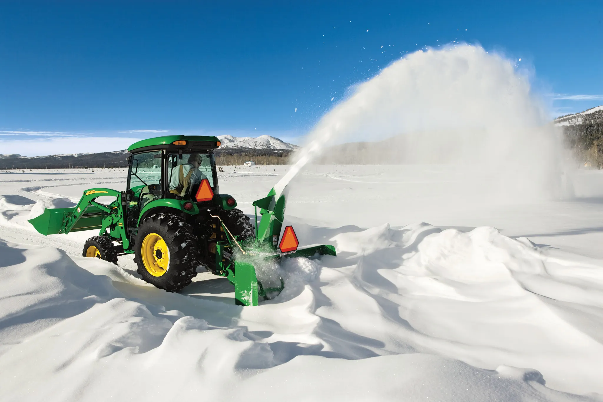 Blowing snow on a driveway using a SB1174 Snowblower on Utility Tractor