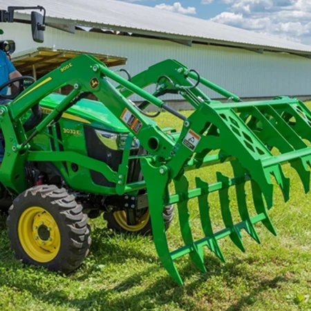 Front right view of an MG20F mechanical grapple with jaws open on a 3032E compact utility tractor