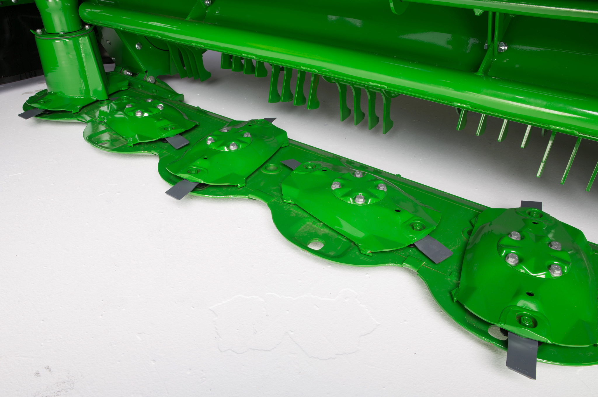Close-up studio view of an R990R mower conditioner's high-speed Rotary Disc Cutterbar