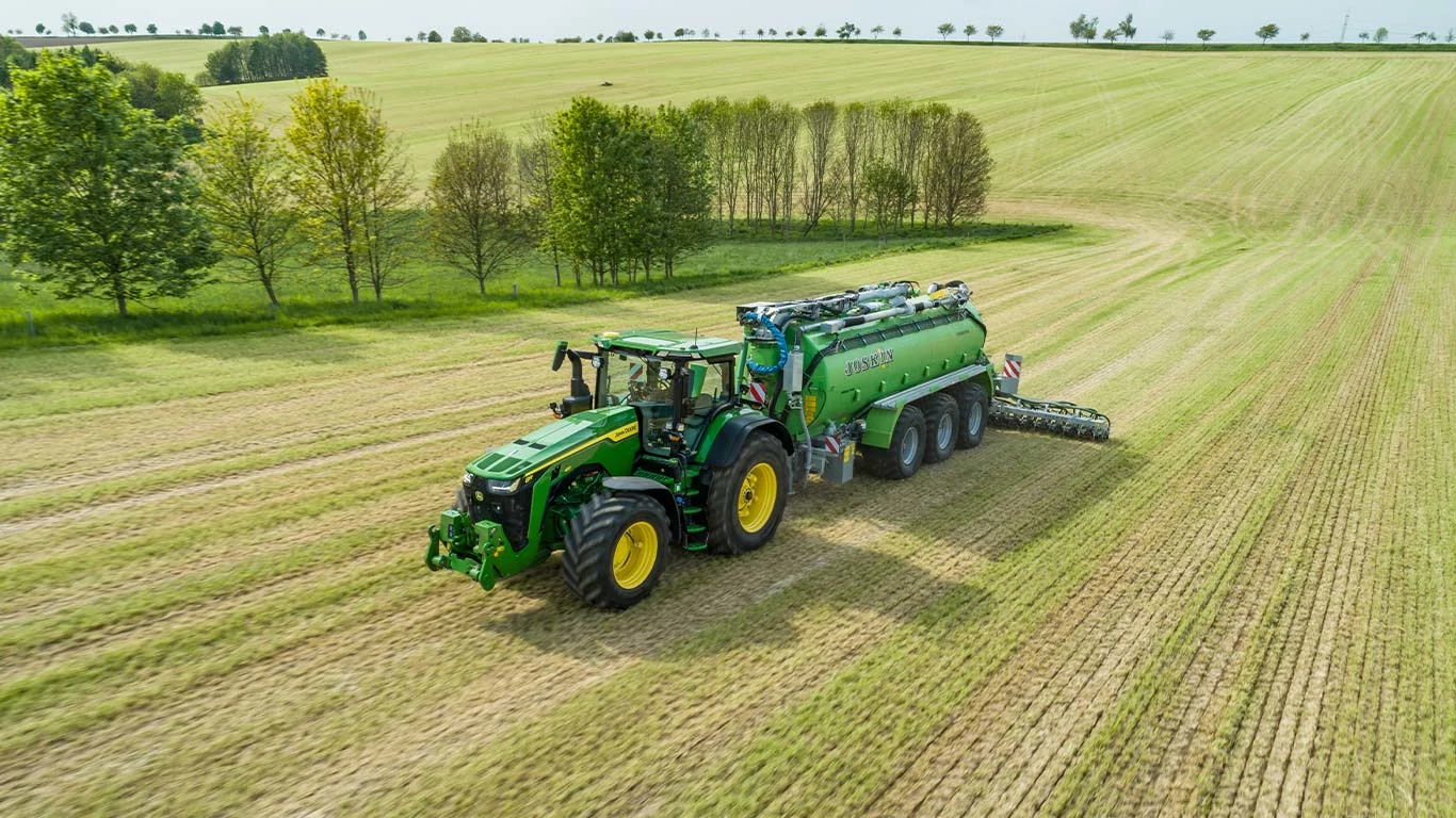 8R Tractor in the field with numerous tracking options