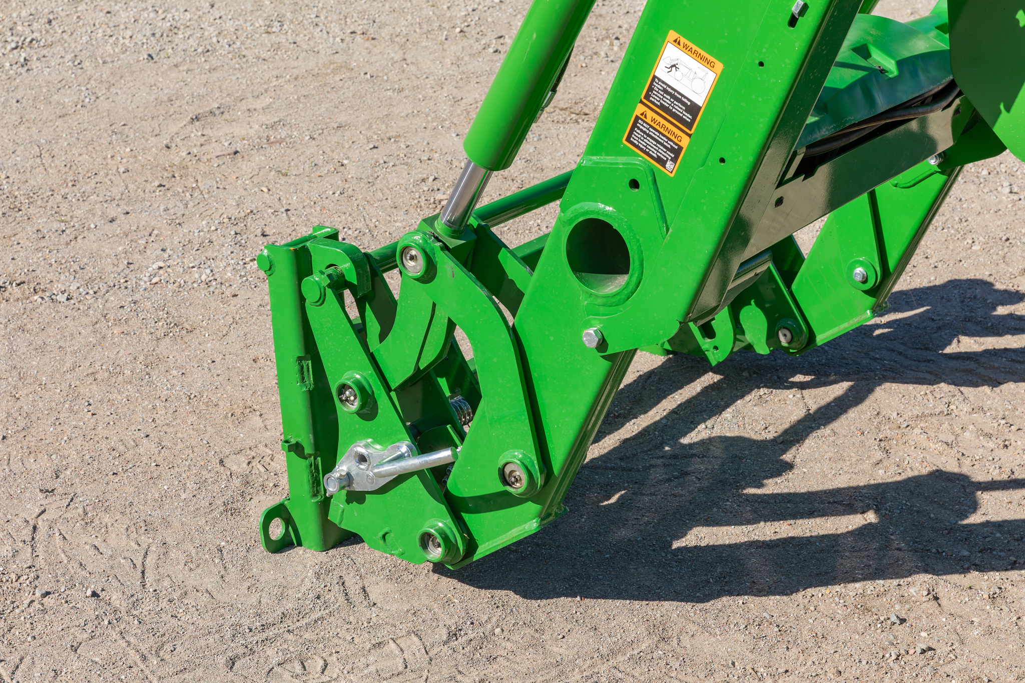Side left view of a DA21G quick-attach carrier adapter on a 5075E tractor