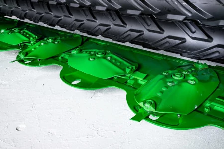 Front, angled studio view of a Mower-Conditioner's quick-change knives within their green metal housing