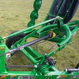 Top, angled view of a DC1000 disc mower caddy's hydraulic lift 3-point hitch with grassy background
