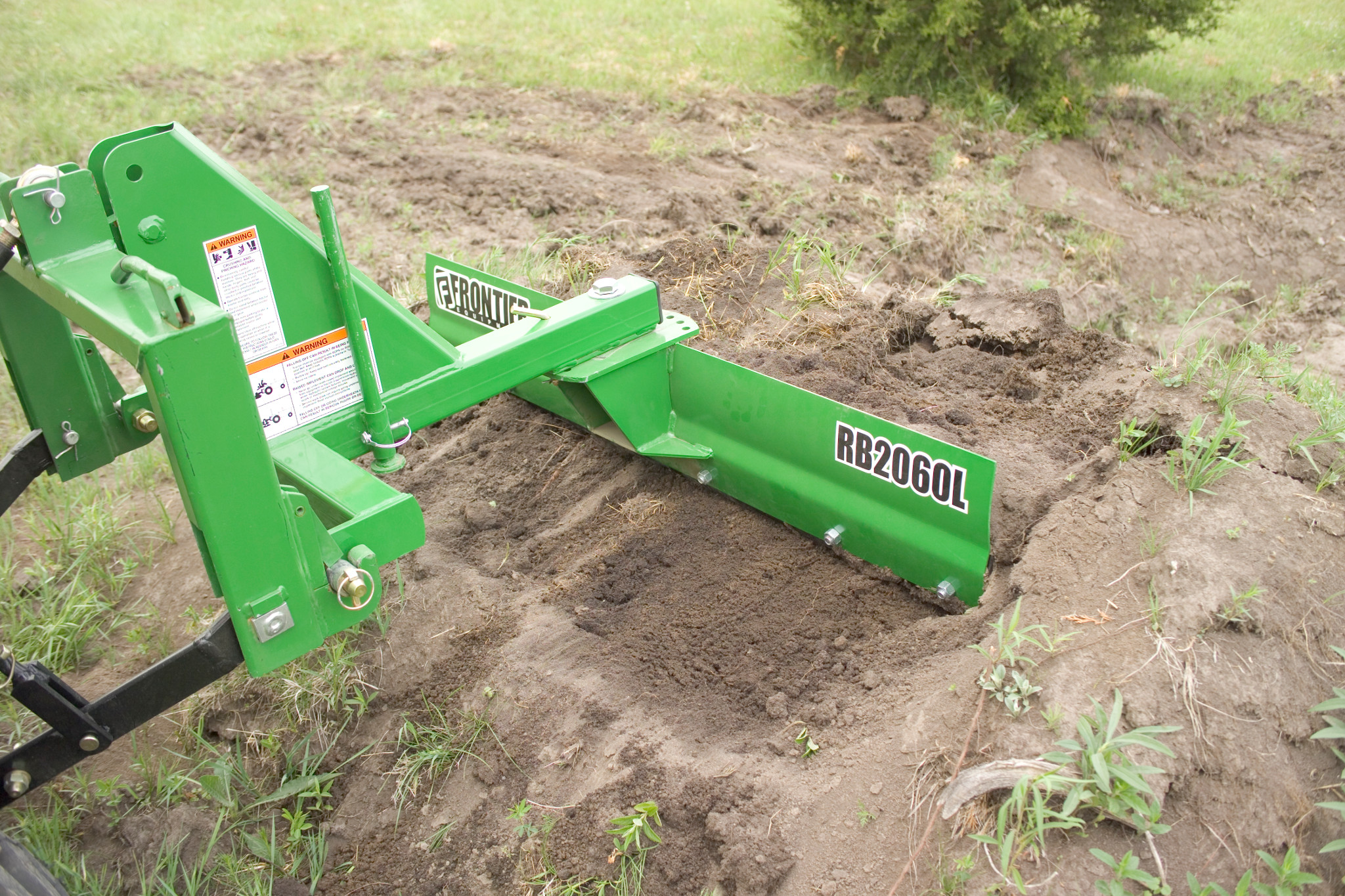 Side right view of an RB2060L Rear Blade at work on a dirt plot