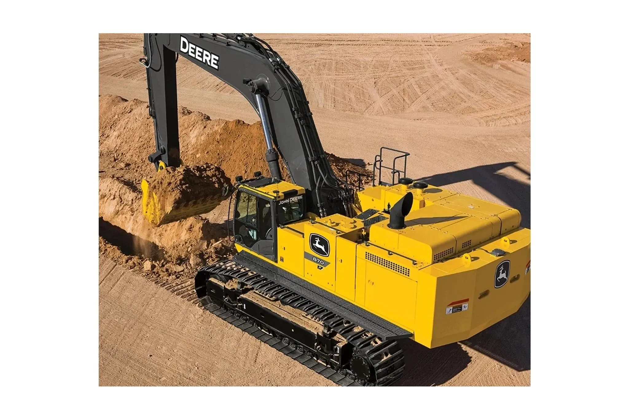 Operator digs a dirt trench with an 870 P-Tier Excavator