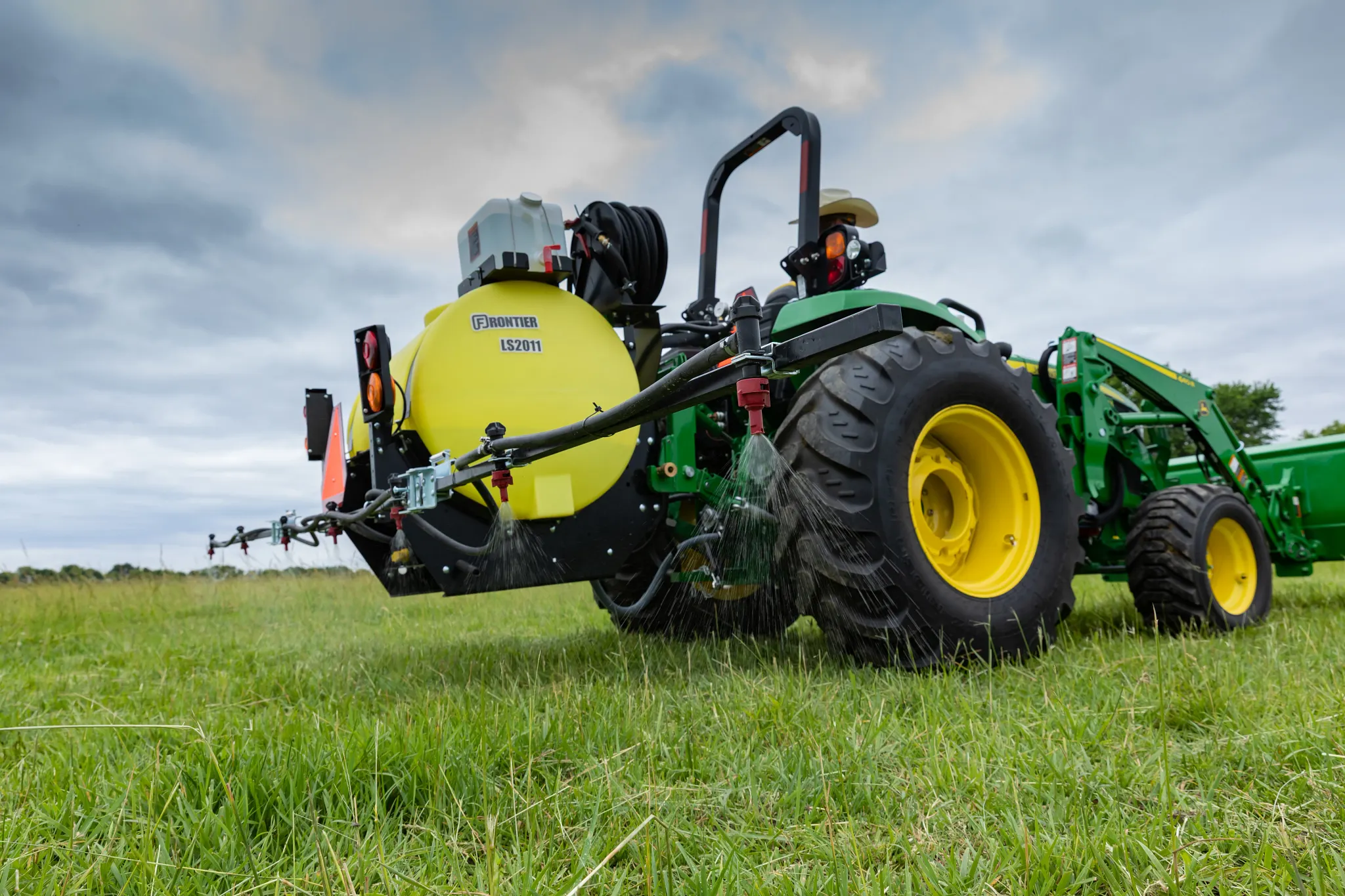 Frontier 3-Point Mounted Liquid Sprayer LS2011 being pulled in the field by a tractor