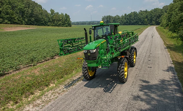 R4023 sprayer in transport mode on a road