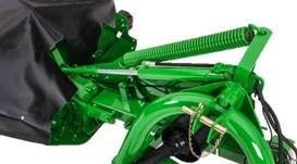 Close-up of the location of a disc mower's green heavy floatation spring in studio