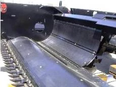 Side left view of the center-feed auger with poly auger pans on a grass seed platform