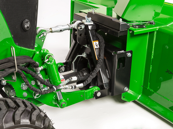 Side angled studio view of a 54 Inch Heavy Duty Snow Blower attaching to a 1025R tractor via front 3-Point Hitch