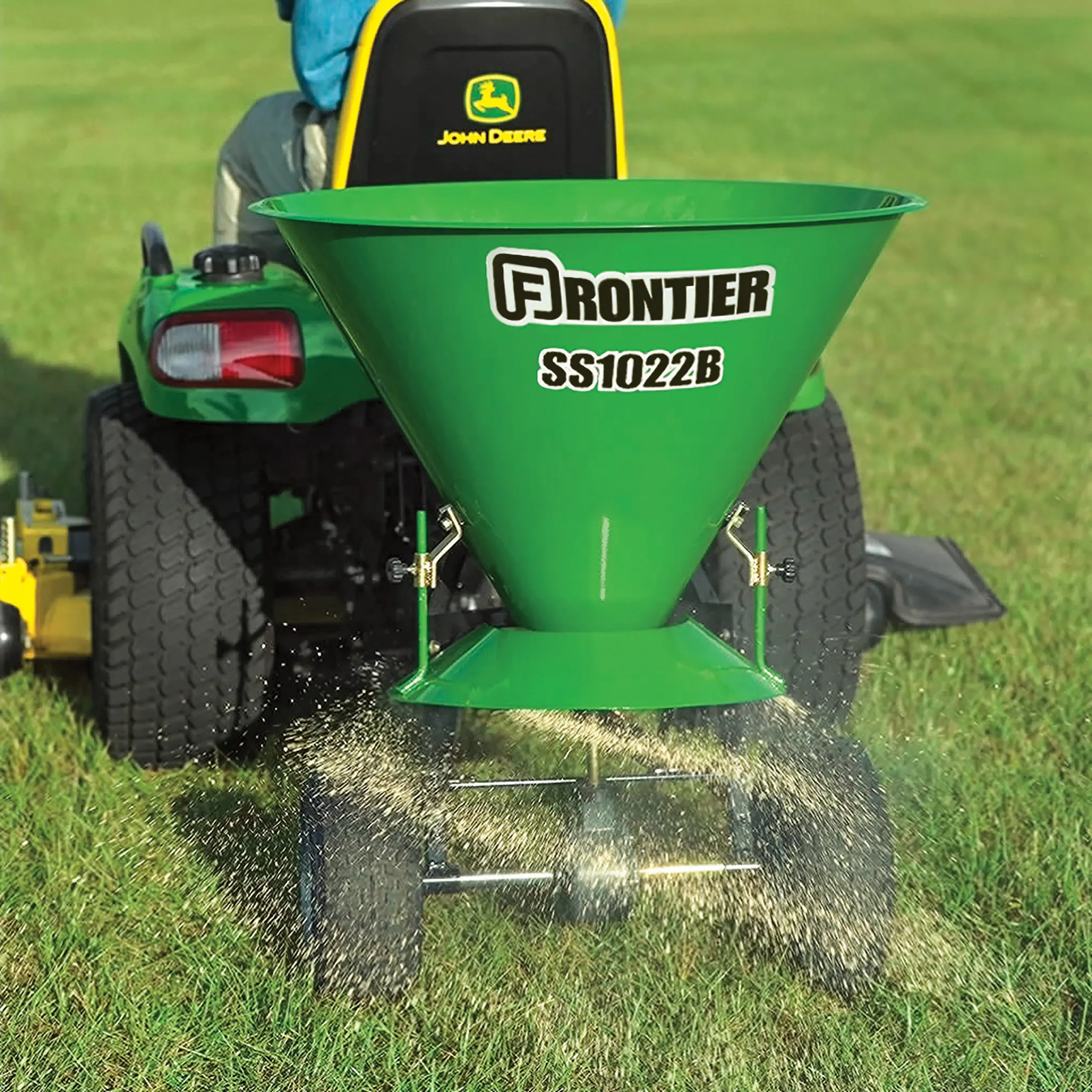 SS1022B spreader on lawn tractor in grass