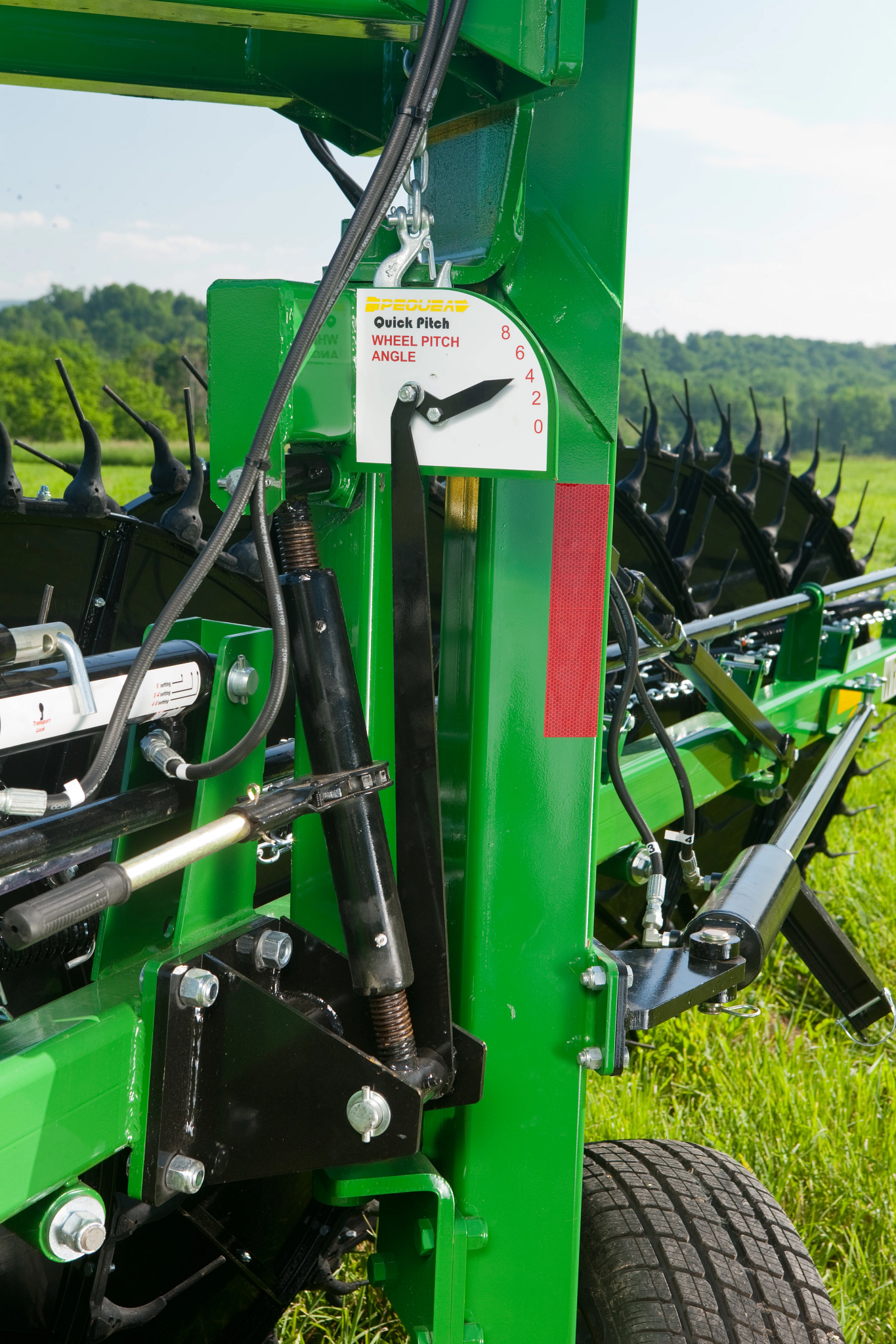 Front view of a wheel rake's corner frame and machinery, where the operator sets the wheel pitch angle