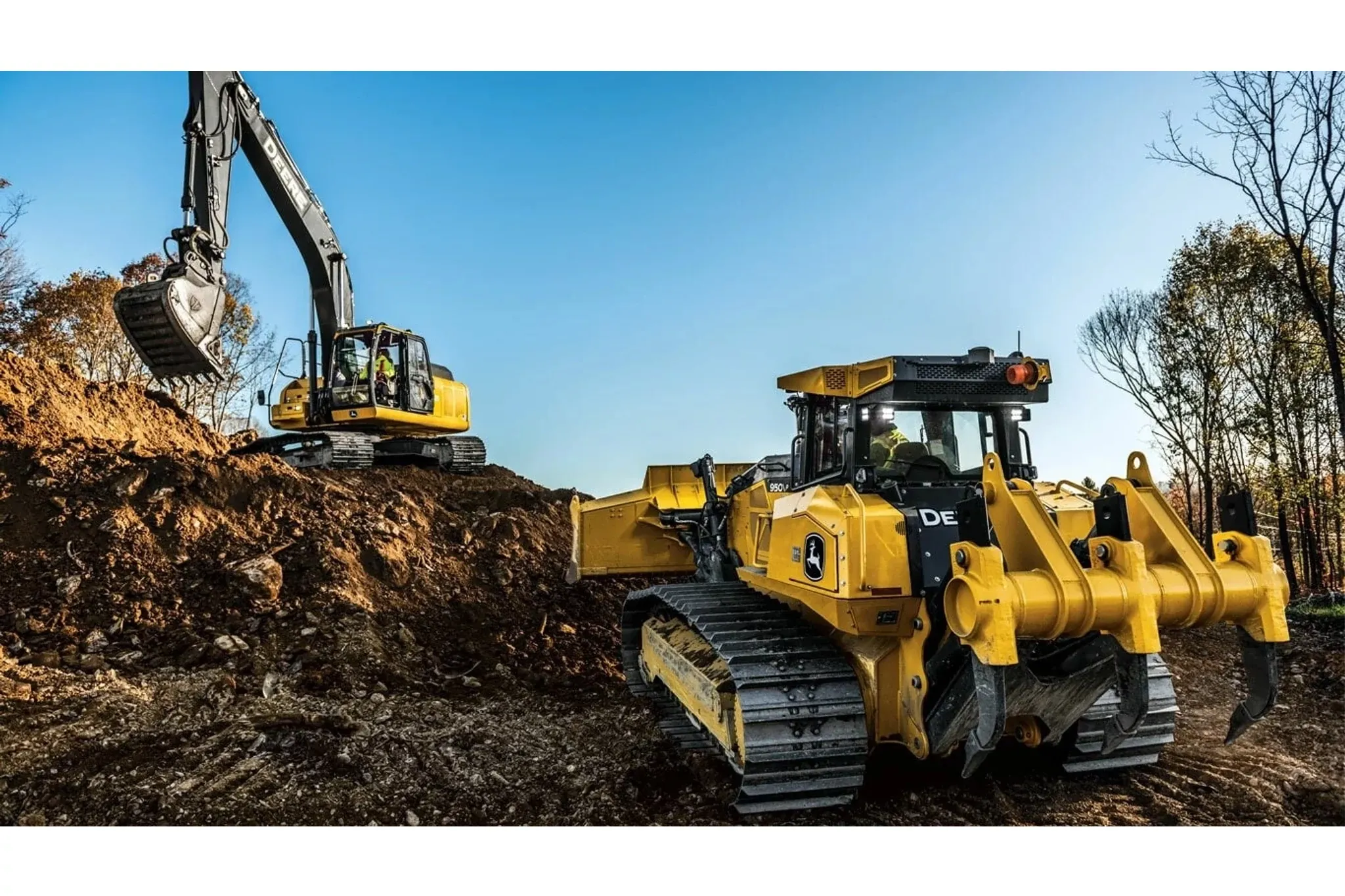 950 P-Tier Large Dozer with a construction equipment at the base of a mound of dirt with an excavator