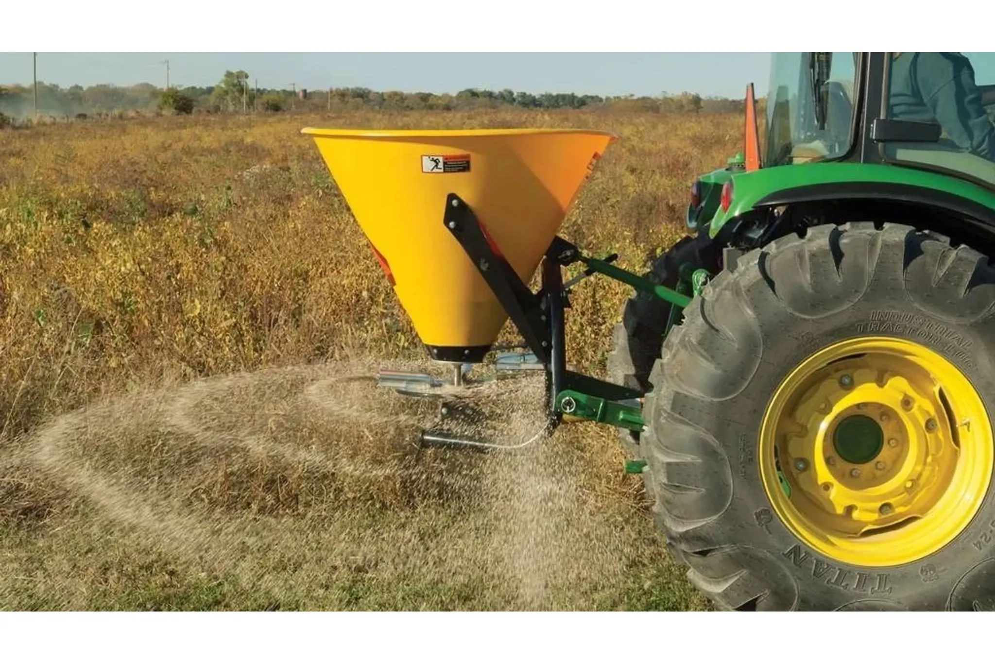 Frontier SB30B broadcast spreader on tractor in field