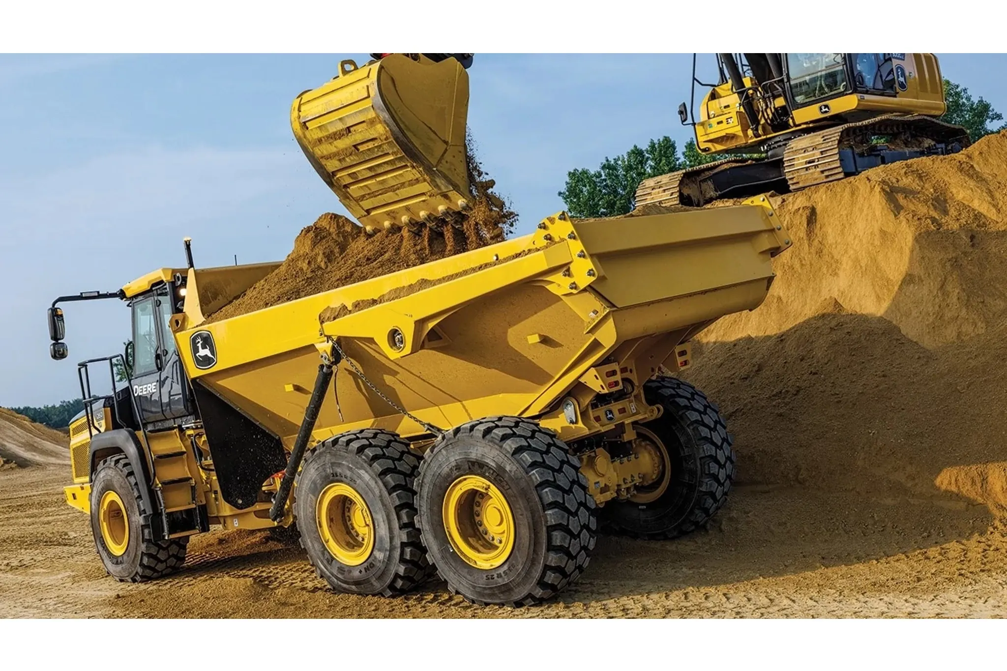260 P-Tier Articulated Dump Truck driving on dirt road with trees in background