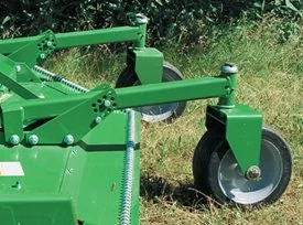 Side view of two grooming mower caster wheels connected to the mower via rail supports resting on the grass
