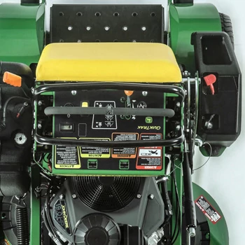 Overhead view of the control panel, rear fenders, operator platform/leaning pad, and half of the motor of a Q810E QuikTrak™ Stand-On Mower