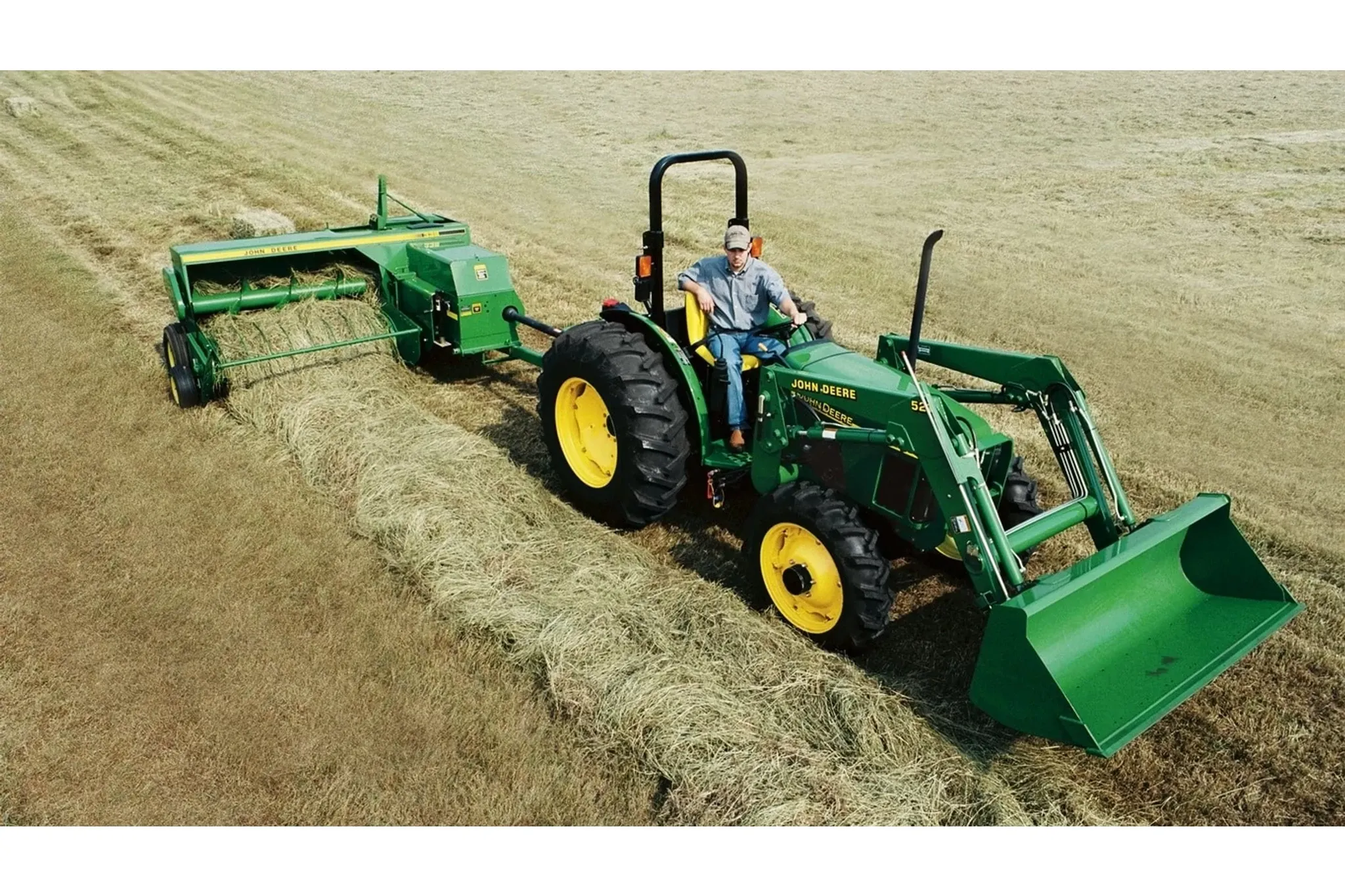 Small Square Balers 338 Small Square Baler with a tractor with a farmer driving it on a field