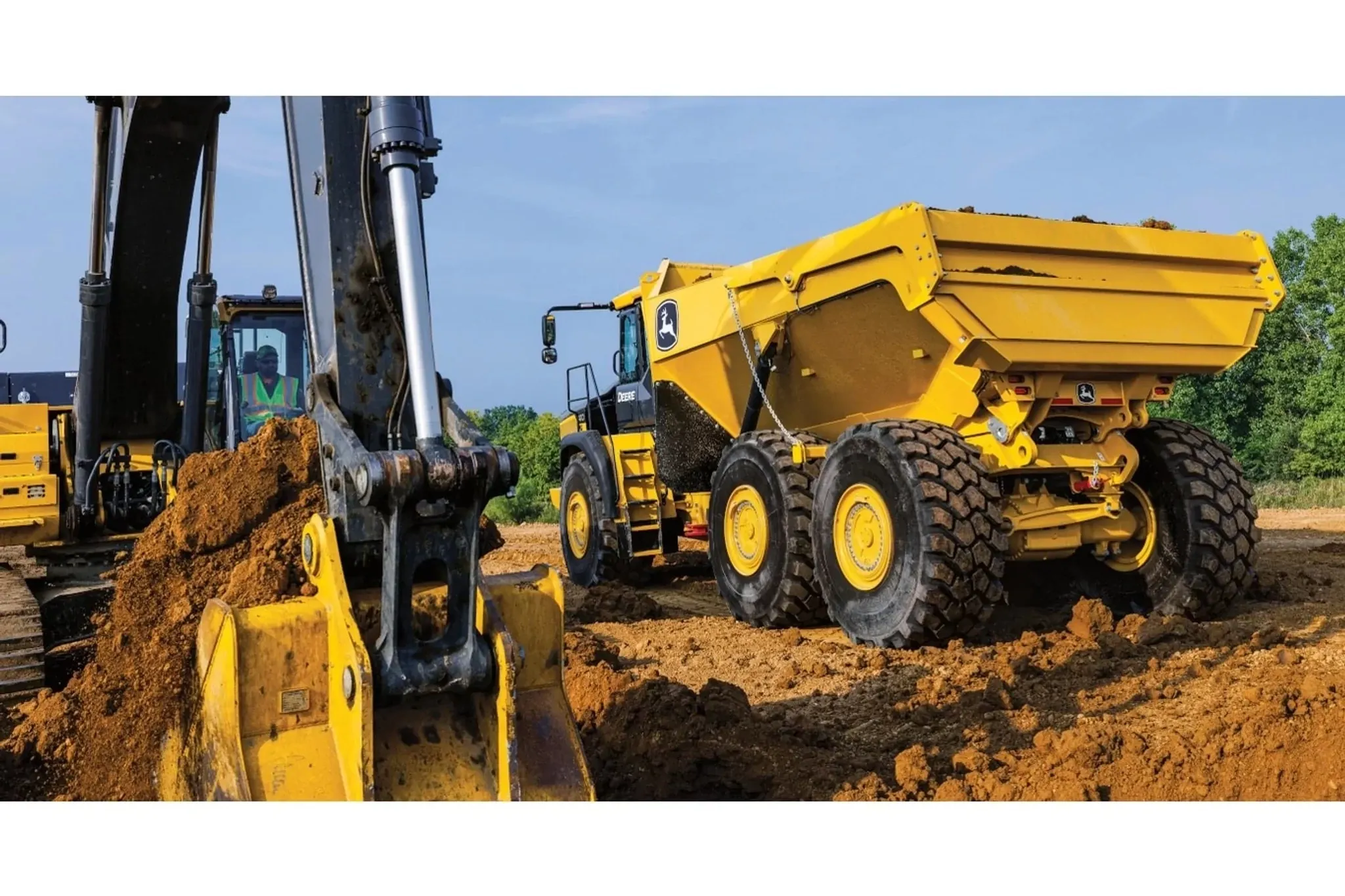 410 P-Tier Articulated Dump Truck on a jobsite by an excavator