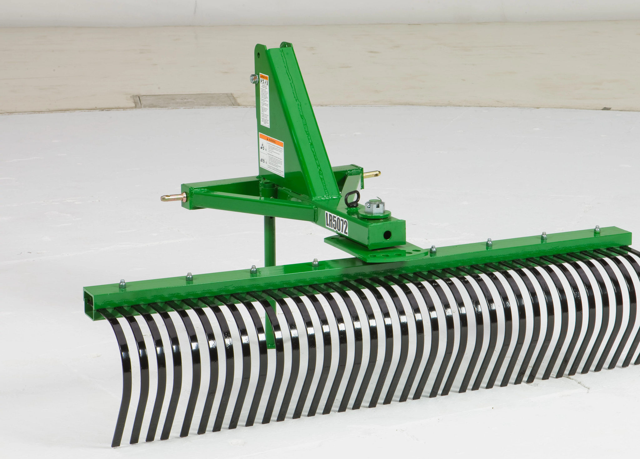 Front right studio view of an LR5072 landscape rake, featuring tubular Steel Frame and Angled Tine Beam