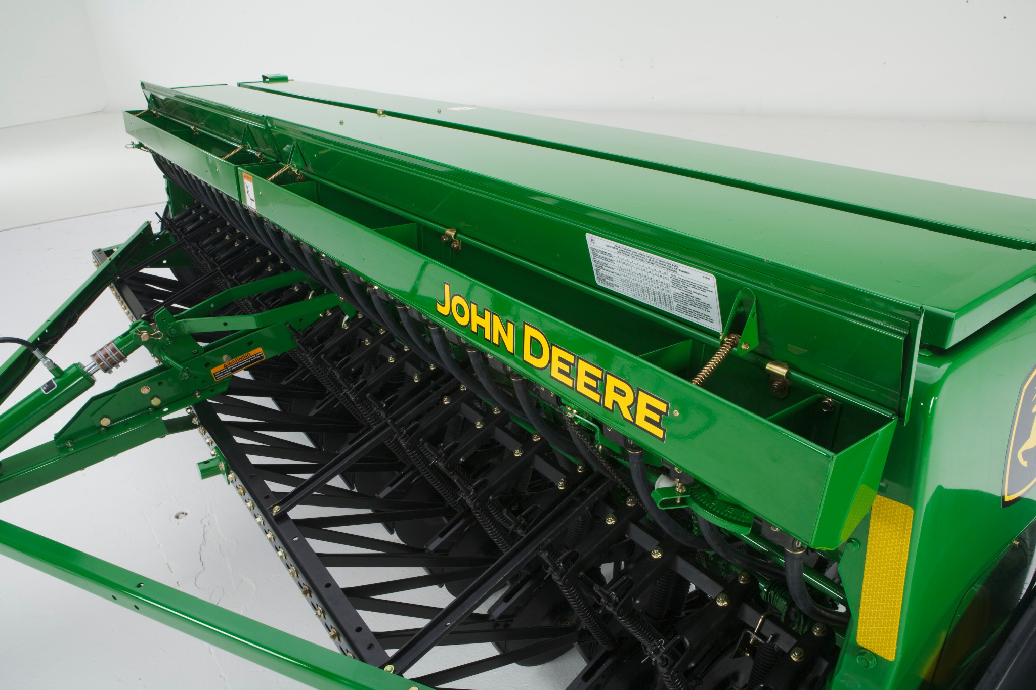 Front left studio view of grass seedbox attached across the top front of a BD11 End-Wheel Grain Drill