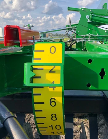Front view of the large yellow measuring tape on a 2660VT vertical tillage, where the gang angle is adjusted