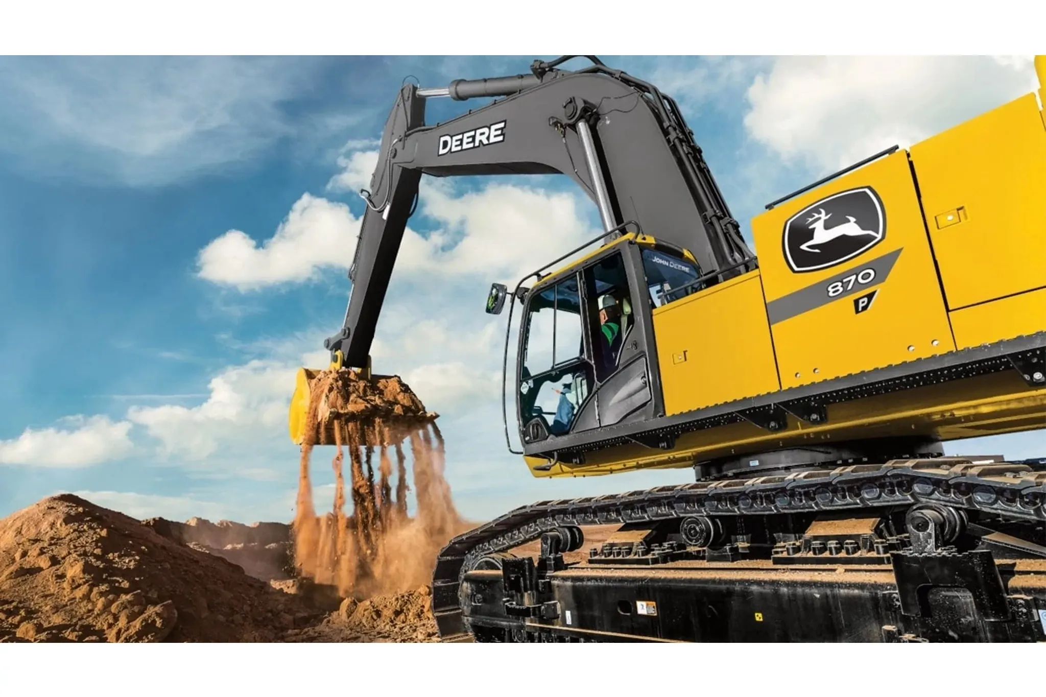 870 P-Tier Excavator on a jobsite with dirt flowing thrugh the bucket