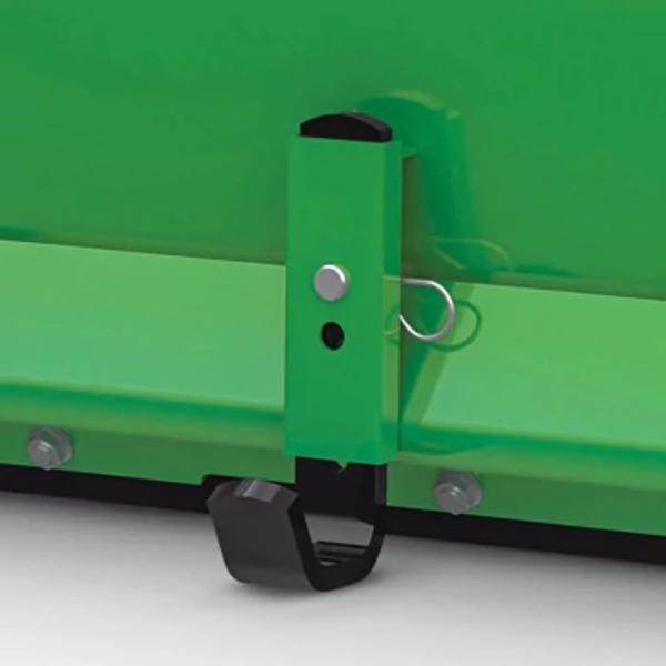 Close‑up of a green equipment attachment bracket showing a vertical mounting tab with a spring‑clip pin and black hook beneath.
