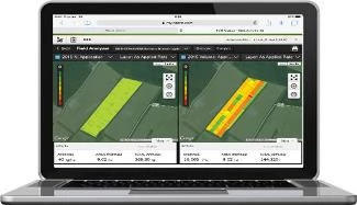 A laptop displaying two side‑by‑side field analysis maps with color‑coded data showing application and performance levels