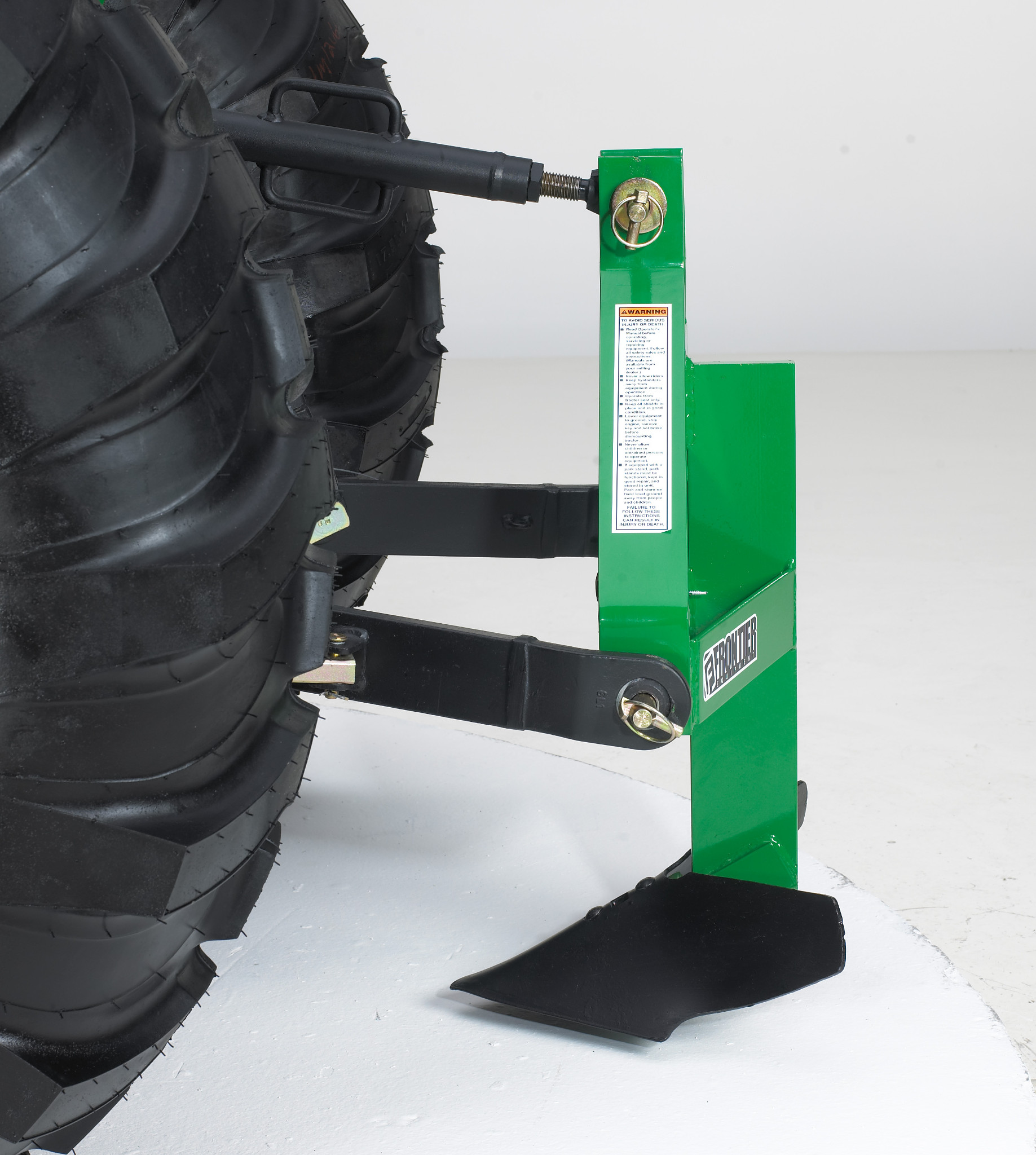 Side studio view of PM10 Middle Buster attached to the hitch of a tractor